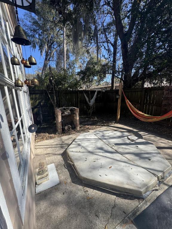 a concrete patio with a hammock in a yard at Townhouse 2 bed 2 bath neat and comfy in Gainesville