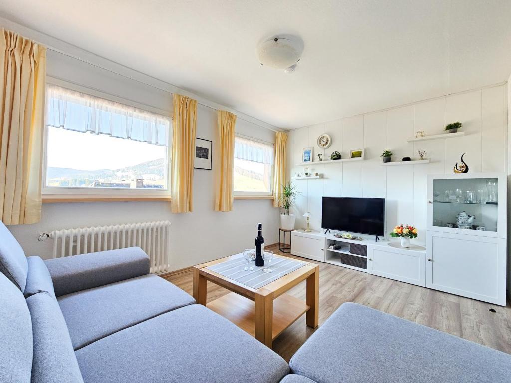 a living room with a couch and a table at Haus Rosenfelder Fewo Abendsonne in Bernau im Schwarzwald