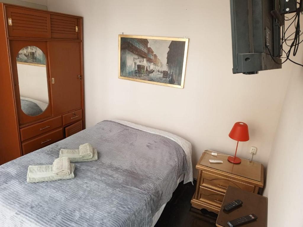 a bedroom with a bed with a cross on it at Lima Centro Guest House Barrios in Lima