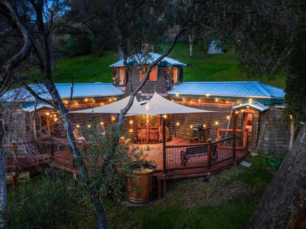 a house with lights on the front of it at Halfling House w/hot tub/firepit/more! in Coarsegold