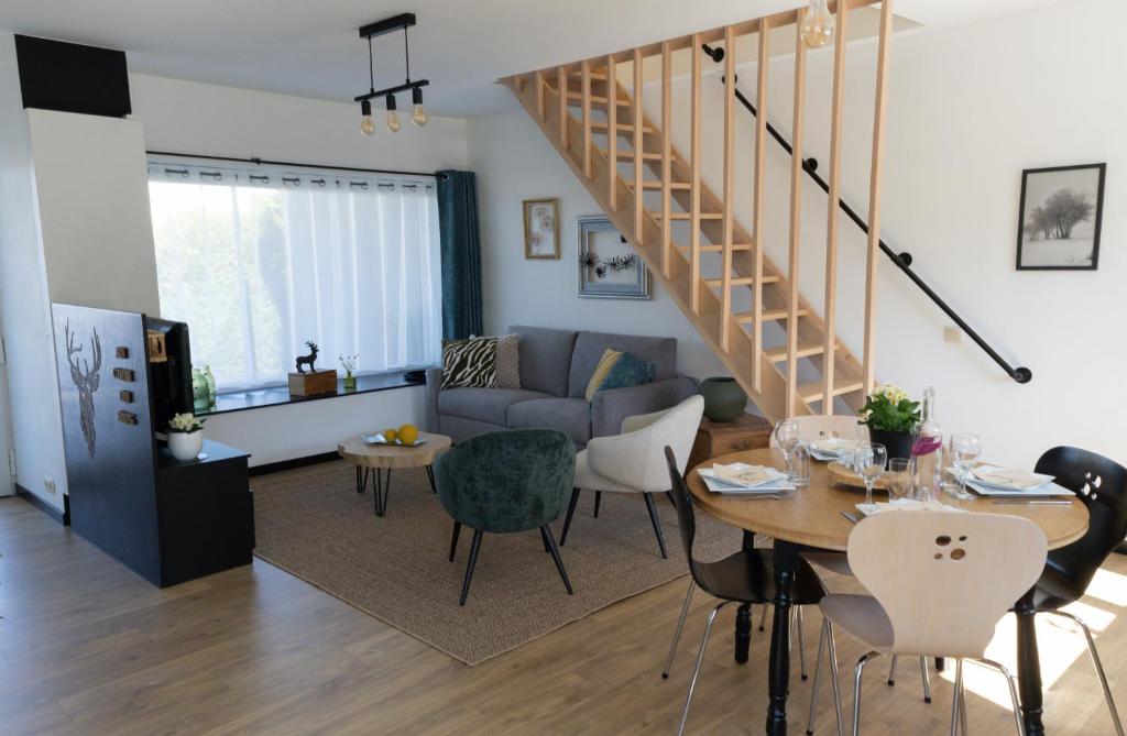 a living room with a couch and a table at Au Coin du Bois in Manhay
