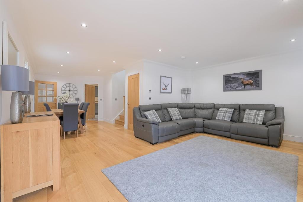 a living room with a couch and a table at Connel House - Luxury self-catering 4-bedroom home in Connel