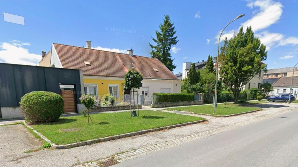 a street with a house with a yellow at Stratos Apartments in Laa an der Thaya
