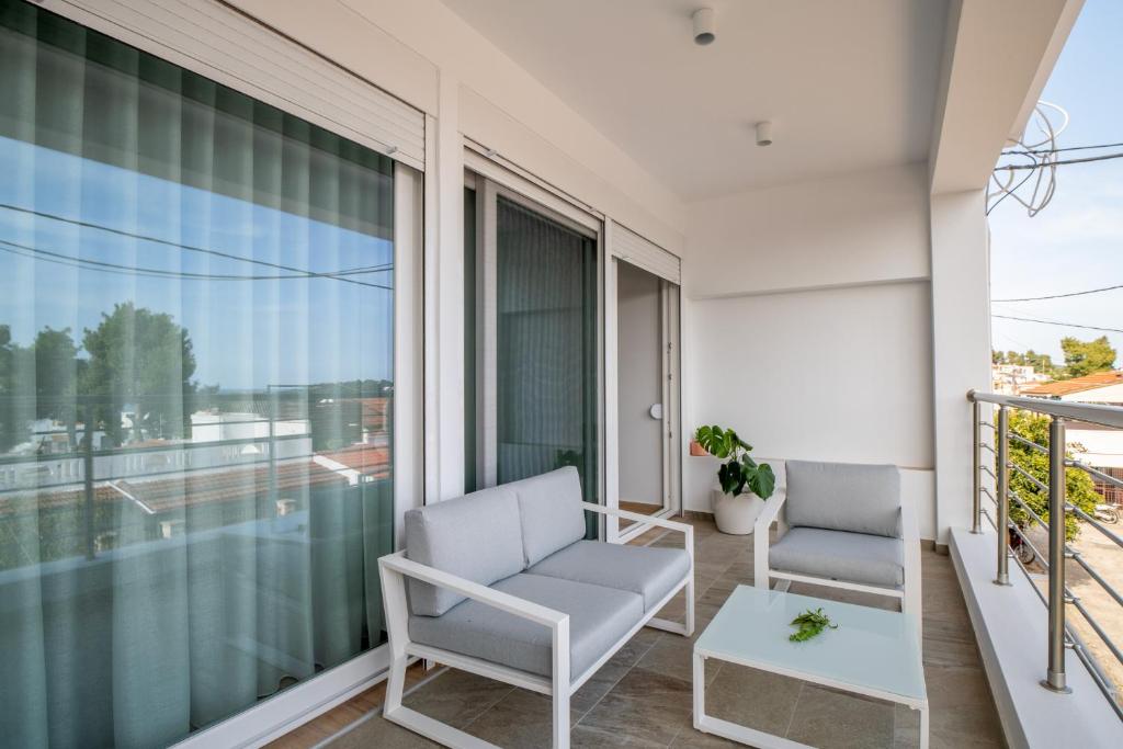 a balcony with two chairs and a table at Casa Angelica in Patitiri