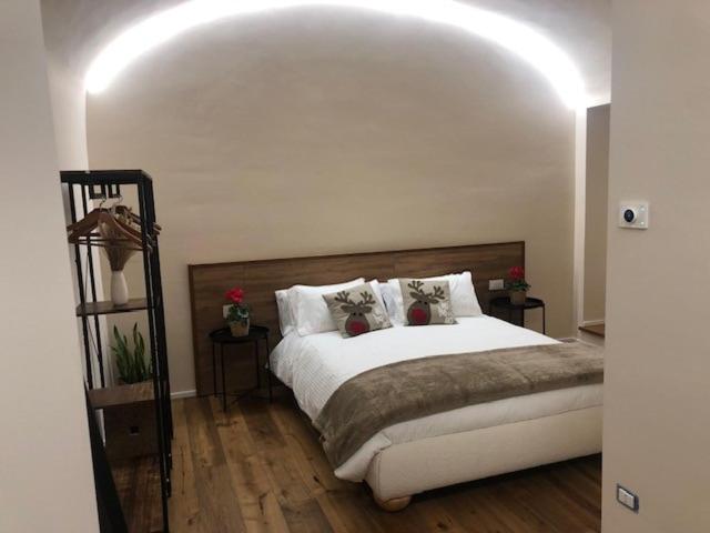 a bedroom with a large bed with white sheets and pillows at Il Cortile del Principe in Castel di Sangro