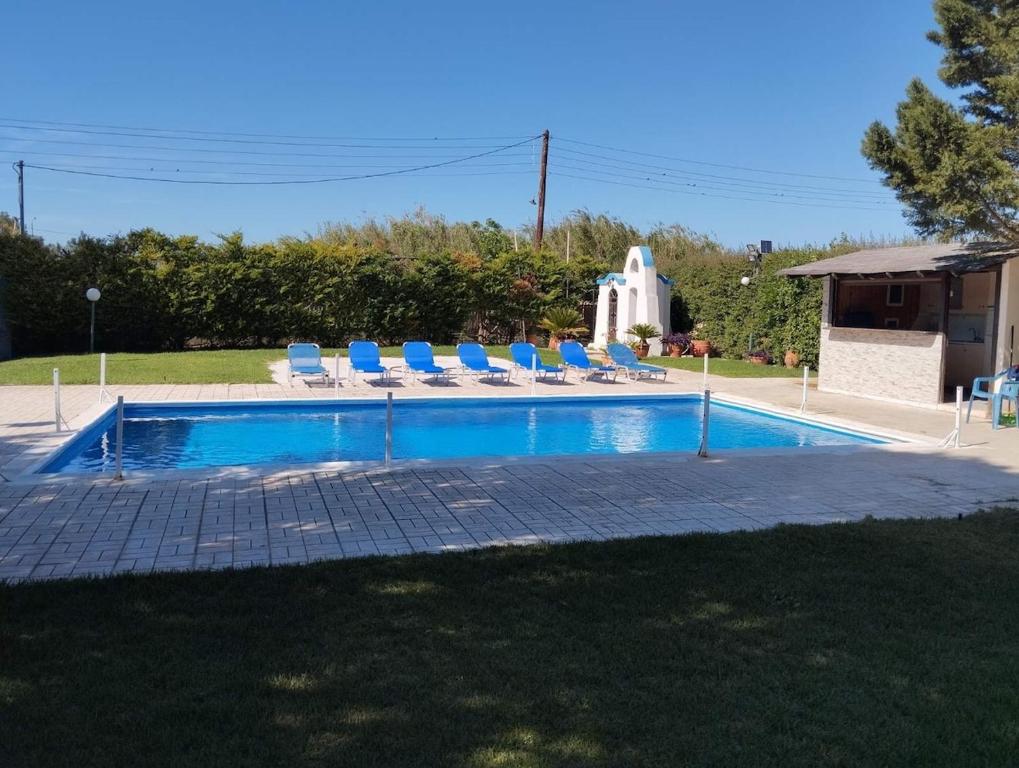 a swimming pool with lounge chairs and a swimming pool at Villa Erato Keratea in Keratea