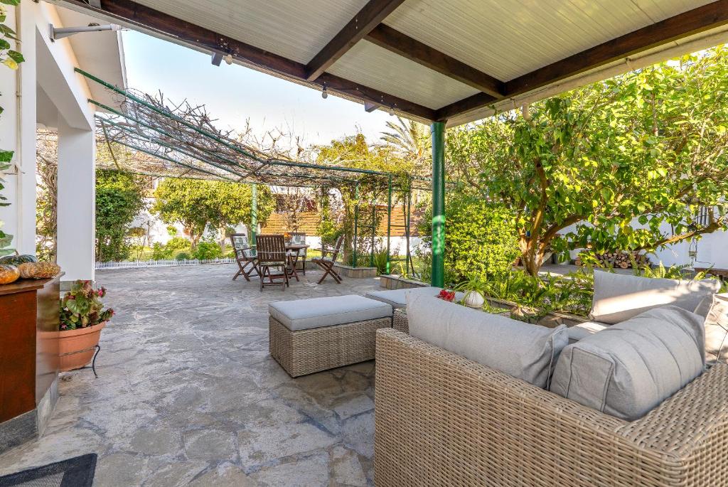 an outdoor patio with a couch and a table at Aquarius View in Archipolis