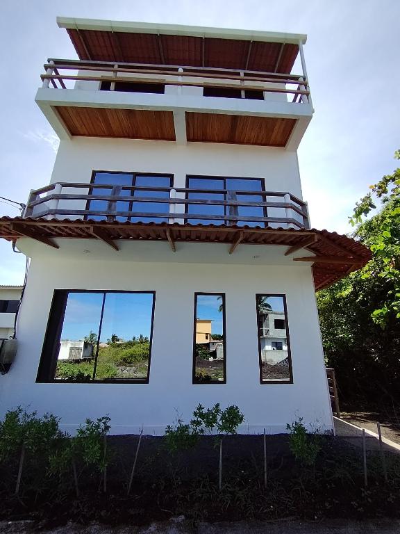 a house with four windows on the top of it at Casa Almendro in Puerto Villamil