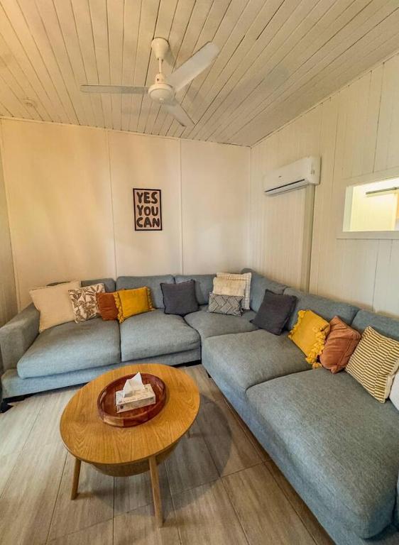a living room with a couch and a table at Panacea Rising in Yeppoon