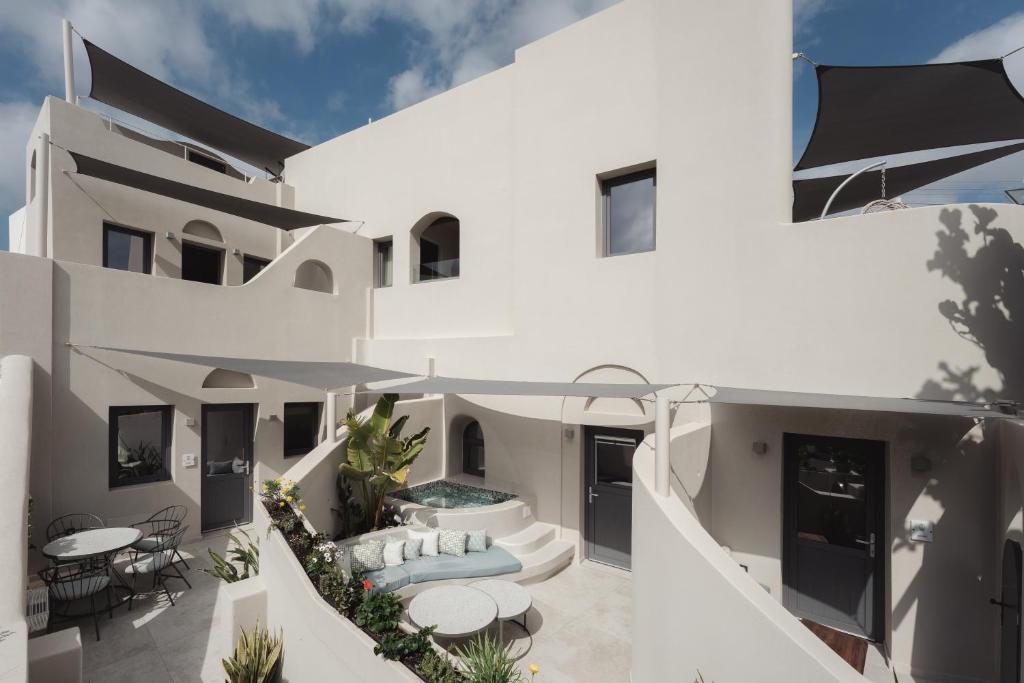 an external view of a white house with a patio at Galaria Serenity Suites in Vóthon