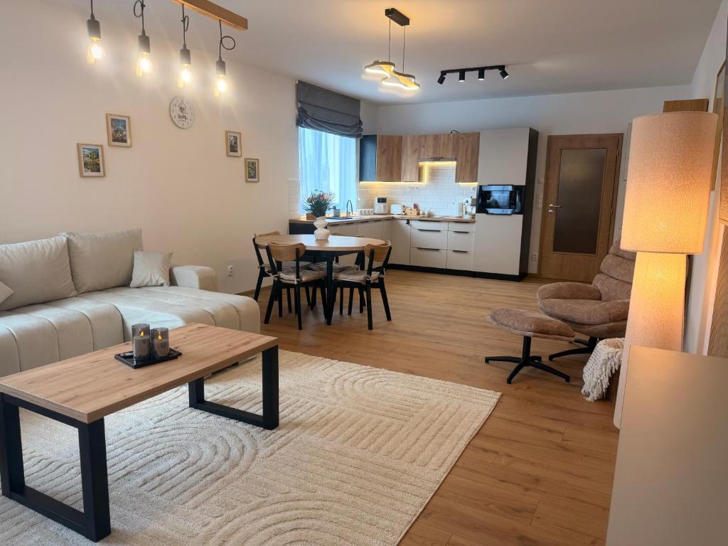 a living room with a couch and a table at Apartmán SteMa Home in Františkovy Lázně