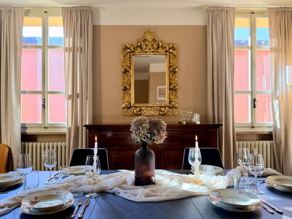 a dining room with a table with a mirror at Volto Santo - Sacred Residence - Piazza Maggiore in Bologna