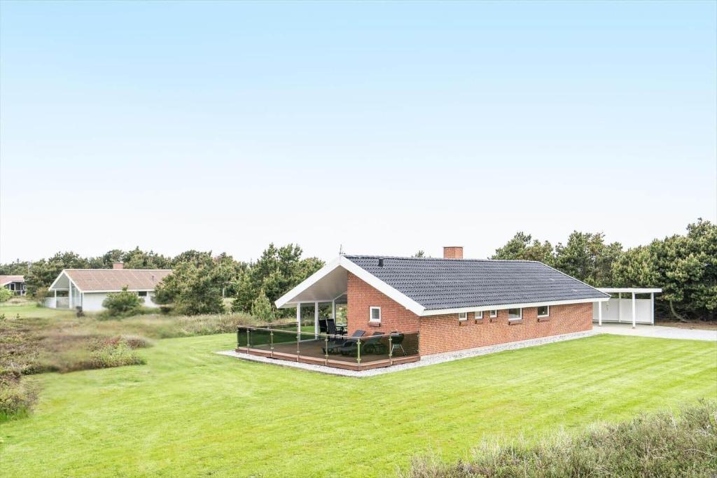 a home with a large yard and a house at 232-Ringkobing-Jakob-Bondes-Vej-35 in Klegod