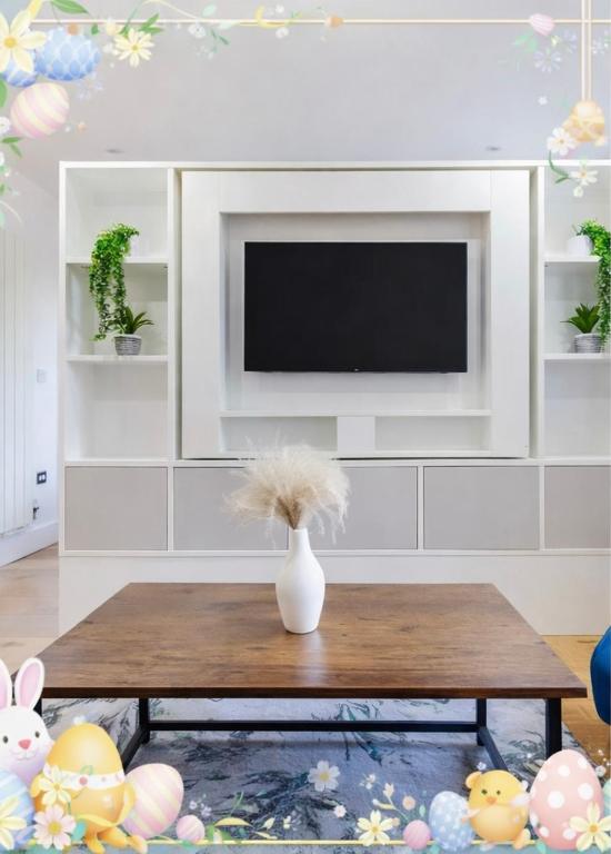a living room with a vase on a coffee table at Long Stay Close To Canary Wharf - Business Travelers, Contractors, Small Families in London