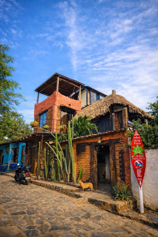 a brick house with a roof with a stop sign at Hugo's Place in Taganga