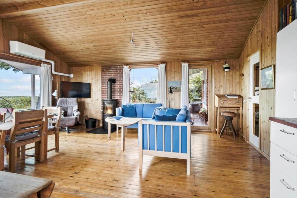 a living room with a blue couch and a table at FY269-Faaborg-Lille-Stege-2 in Faaborg
