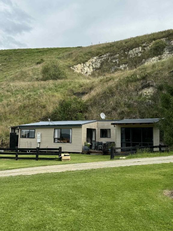 a house on the side of a hill at Lime Ridge Farm Cottage in Fairlie