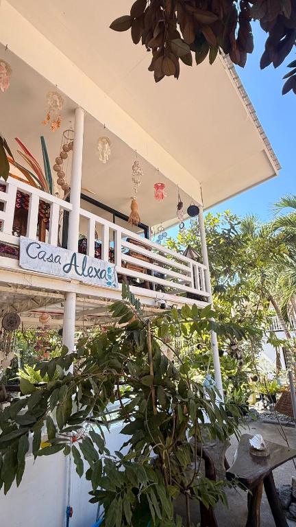a white house with a sign on the front of it at Casa Alexa - Island Escape in Puerto Princesa City