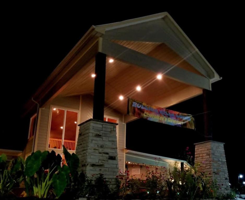 a house with lights on top of it at night at Rolling Hills Lodge in Cherokee