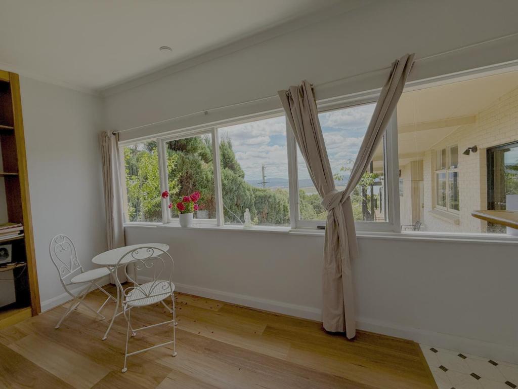 a room with a window with a chair and a table at Tamar Vista Retreat in Legana