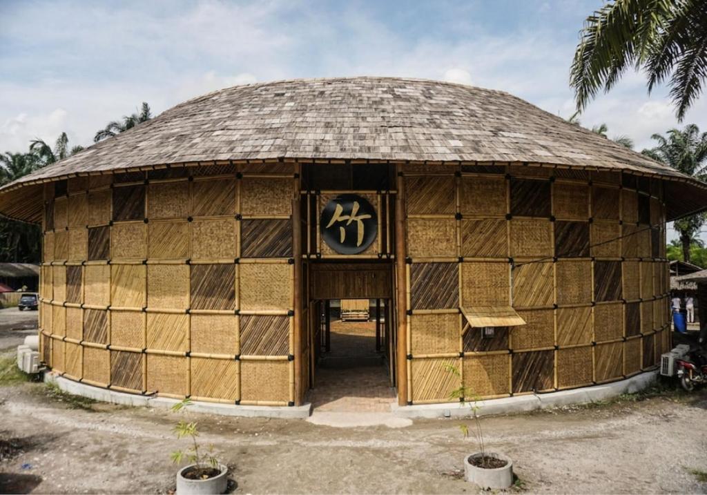 a hut with a sign on the front of it at Tadom Hill Resorts in Kampong Labohan Dagang