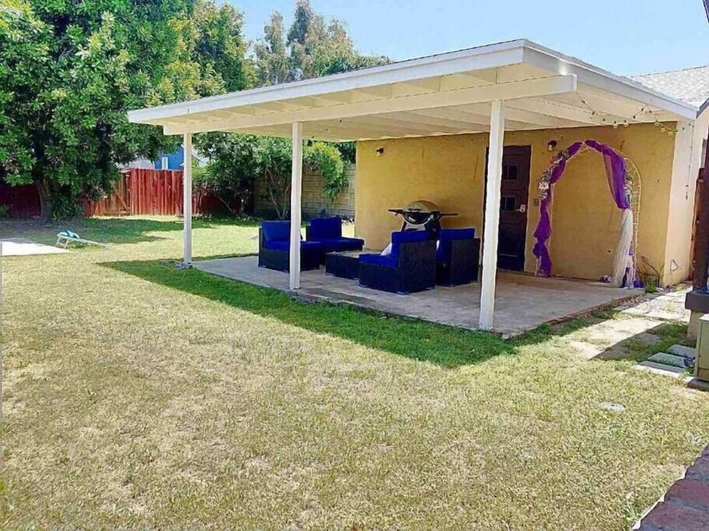 a pavilion with blue chairs and a purple arch at Large Fenced Yard, Pool Table, Disney Central in Fullerton