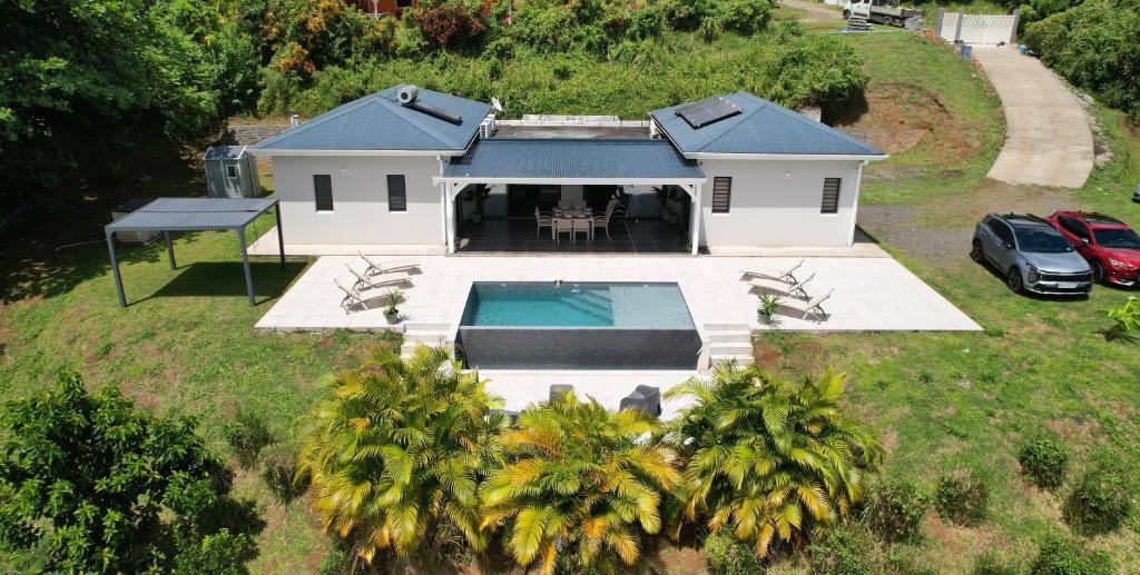 an aerial view of a house with a swimming pool at La Villa Serenity Pool in Le Lamentin