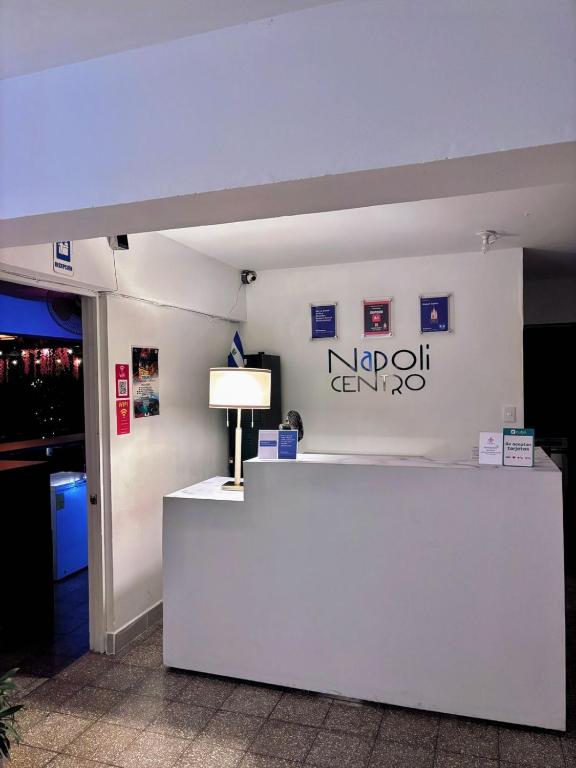 a white counter with a lamp on top of it at Napoli Centro in Santa Ana
