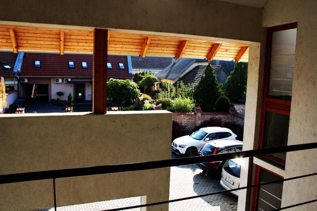 a car parked in a driveway outside a house at AIDA Apartman in Gyula