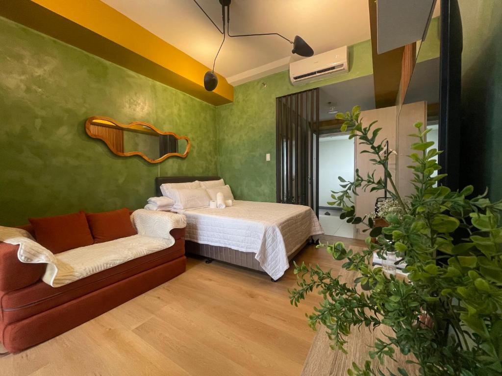 a bedroom with a bed and a couch at Rm Staycation City View SMDC in Kaybagal