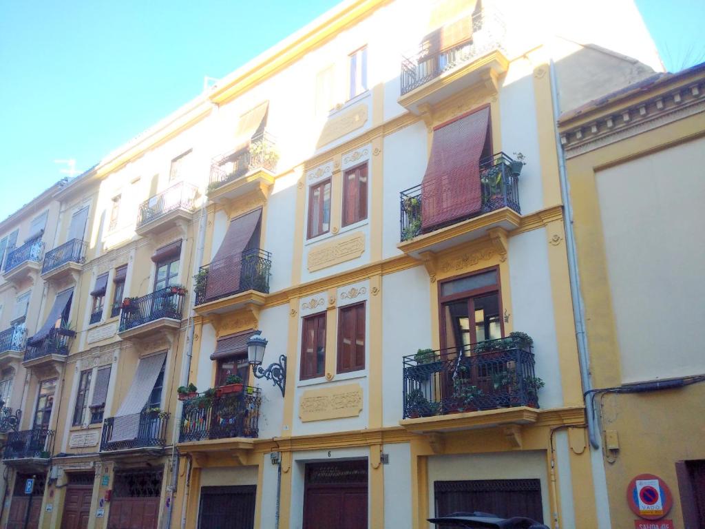 a large white building with balconies on a street at Quart Silence in Valencia