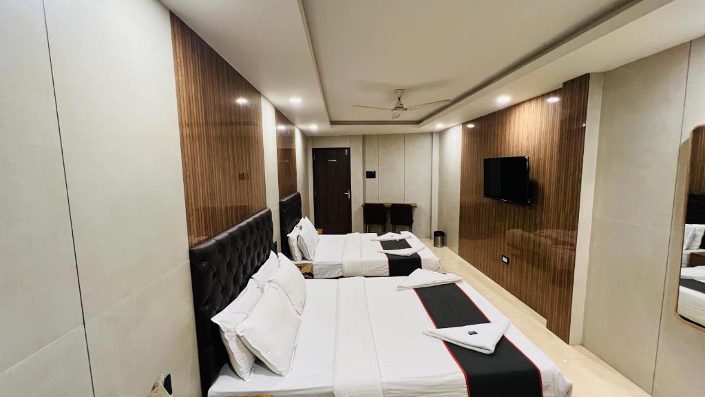 a row of beds in a hotel room at Hotel U Life Residency Mumbai in Mumbai