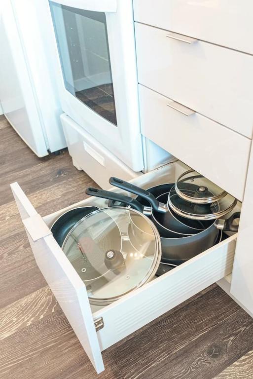 a drawer in a cabinet filled with pots and pans at 2 BHK Unit In Core Downtown Cincy in Cincinnati