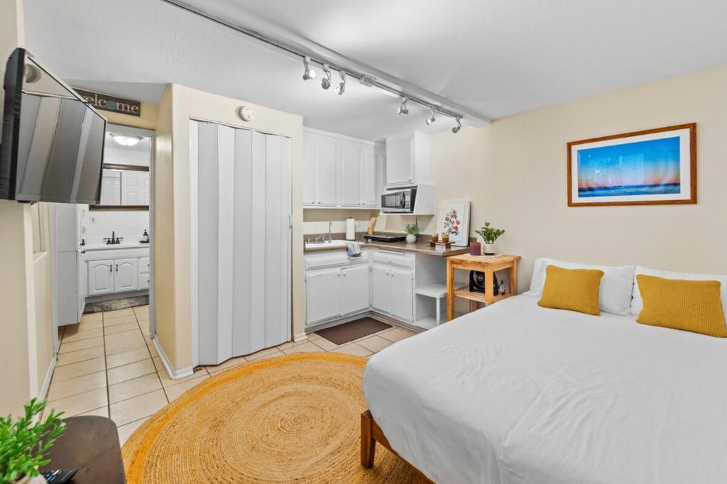 a bedroom with a large bed and a kitchen at Netflix, Stocked Kitchenette, Beach Gear in Ventura