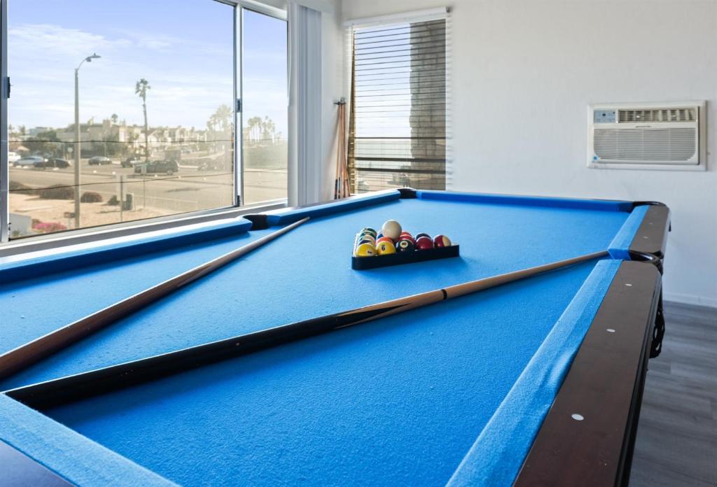 a pool table with a bowl of balls on it at Ocean View Beach Stay w Pool Table & Bikes in Oxnard