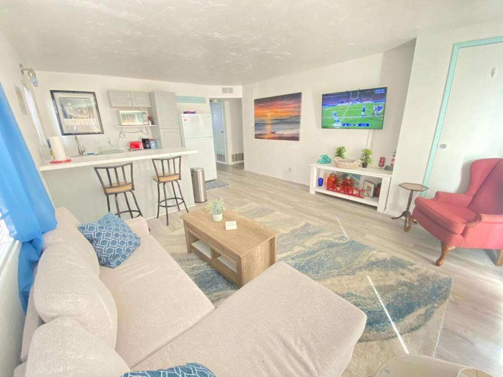 a living room with a white couch and a red chair at Sea View, Boards, Bikes, Wd in Oxnard