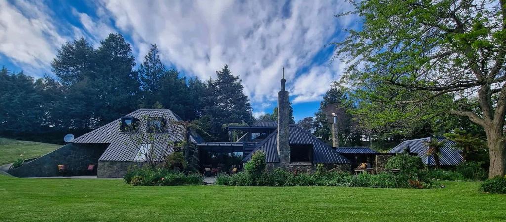 a large house with a church in a yard at Edwoods Boutique Bed & Breakfast in Oamaru