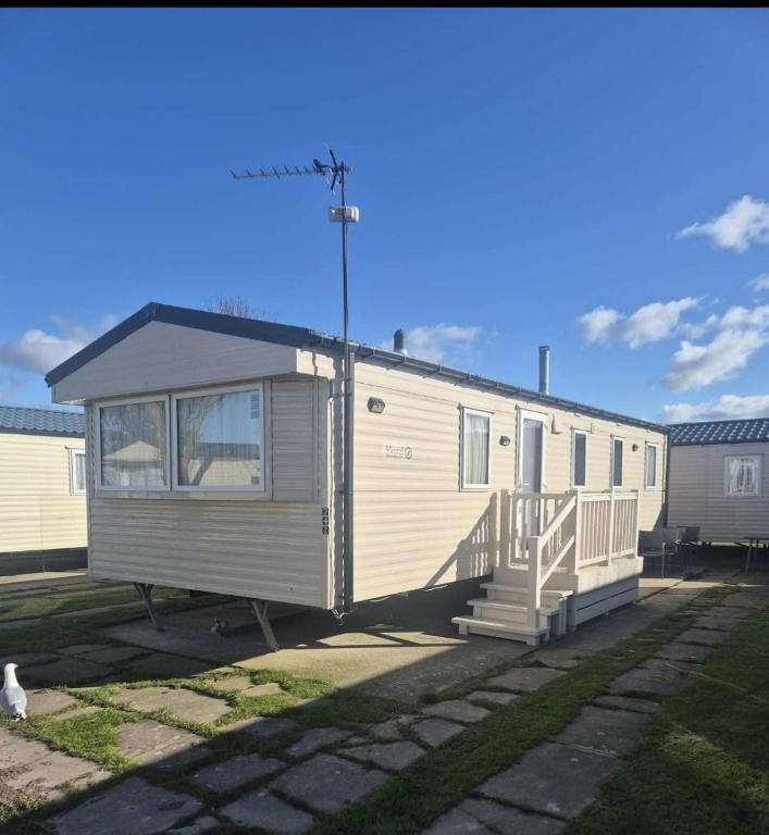 a tiny house is parked in a yard at 3 bed Caravan wink ups towyn in Kinmel Bay
