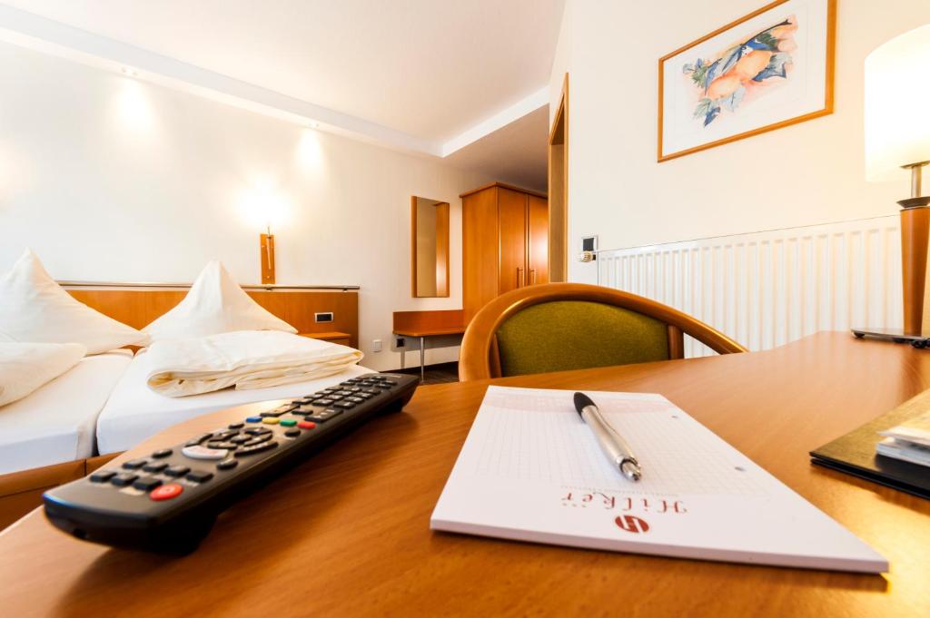 Postel nebo postele na pokoji v ubytování Hotel Hilker