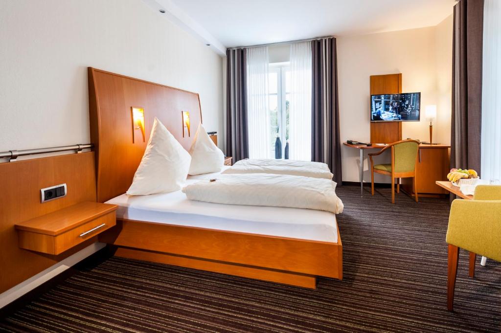 Postel nebo postele na pokoji v ubytování Hotel Hilker