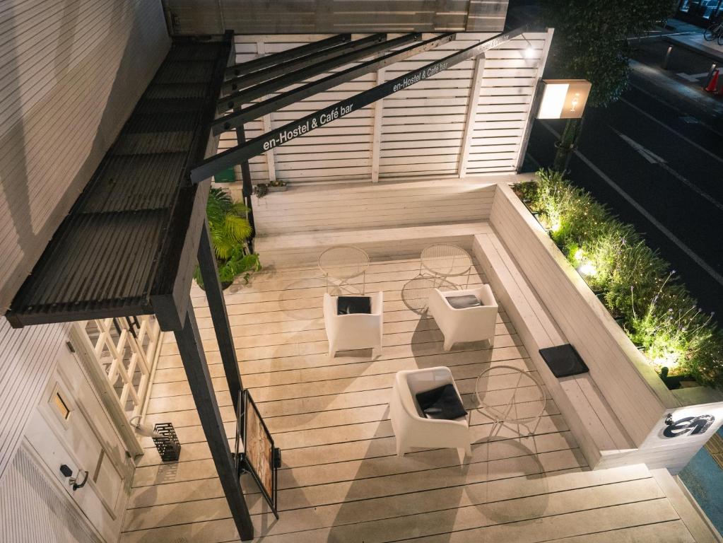 an overhead view of a patio with two tables and benches at En- Hostel & Café bar in Amami
