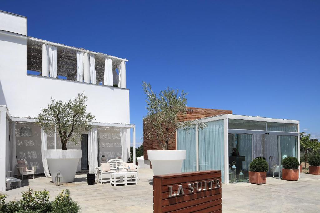 a patio with a building with a glass extension at La Suite Boutique Hotel in Procida