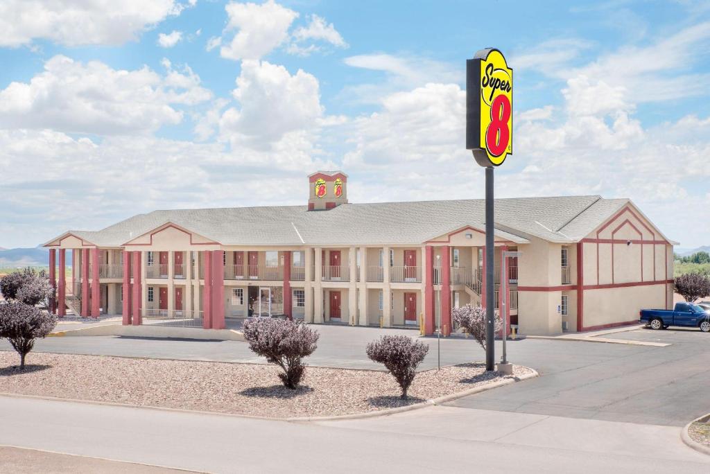 a building with a mcdonalds sign in front of it at Super 8 by Wyndham Van Horn in Van Horn