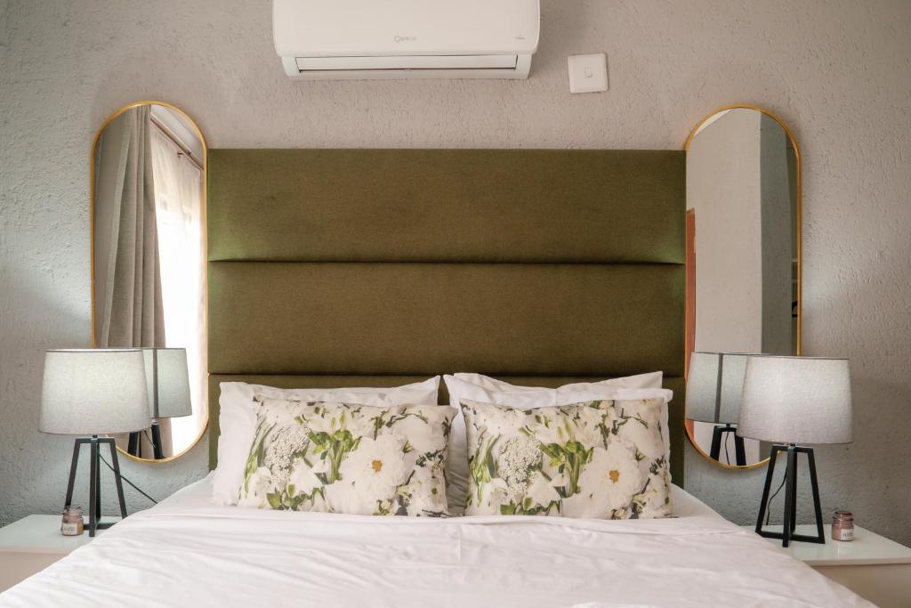 a bedroom with a large bed with two lamps at Unit 4 at Homely Escapes in Phalaborwa