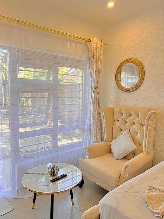 a living room with a couch and a glass table at Luxury Homely Apt studio with pool in Kisumu