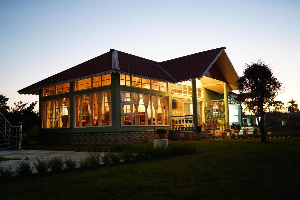 a large building with a lot of windows at Jai Ganesha Resort in Chālsa Mahābāri