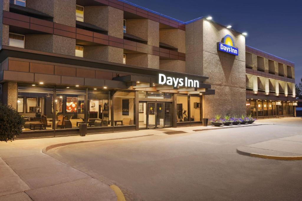 a building with a day inn sign in front of it at Days Inn by Wyndham Vermilion in Vermilion