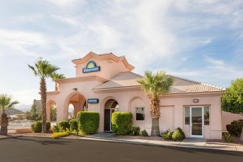 a mobil gas station with palm trees in front of it at Days Inn by Wyndham Bullhead City in Bullhead City