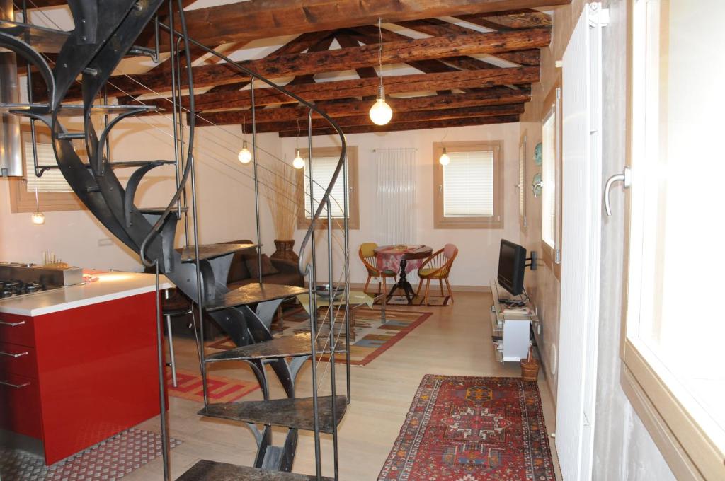 a spiral staircase in a room with a table and chairs at Casa Alba in Venice