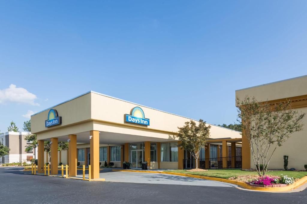 a hotel with a sign on the front of it at Days Inn by Wyndham Madison in Madison